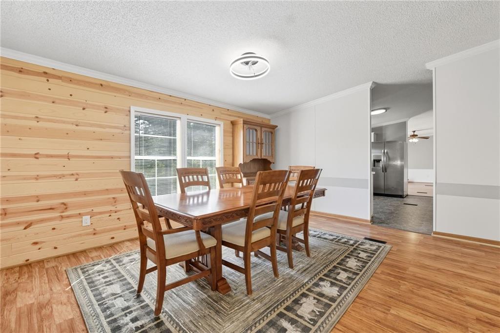 294 Old Ball Ground Road Canton, GA 30115 - Photo 18 of 40 a view of a dining room with furniture and wooden floor