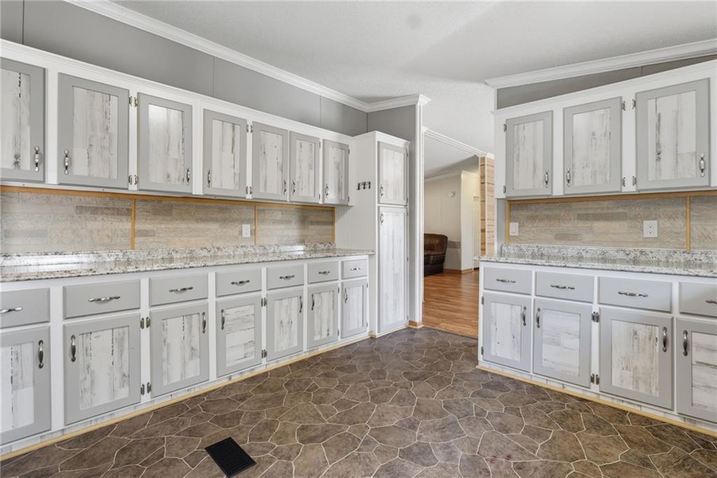 294 Old Ball Ground Road Canton, GA 30115 - Photo 22 of 40 a kitchen with granite countertop white cabinets and stainless steel appliances