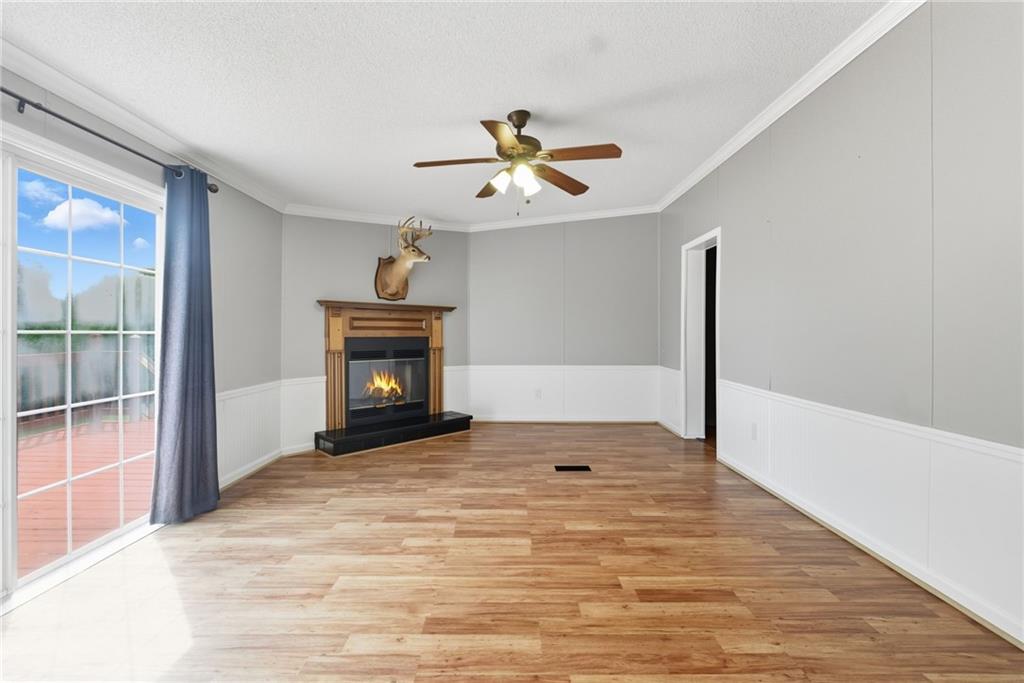 294 Old Ball Ground Road Canton, GA 30115 - Photo 24 of 40 a view of an empty room with a fireplace and a fan