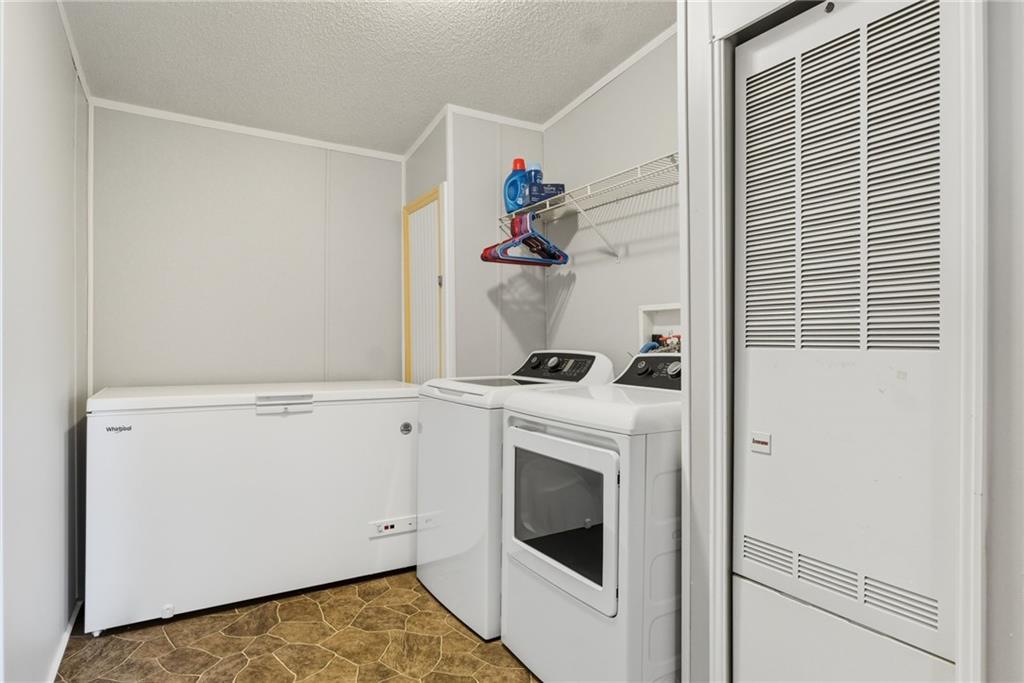 294 Old Ball Ground Road Canton, GA 30115 - Photo 27 of 40 a view of storage and utility room with washer and dryer