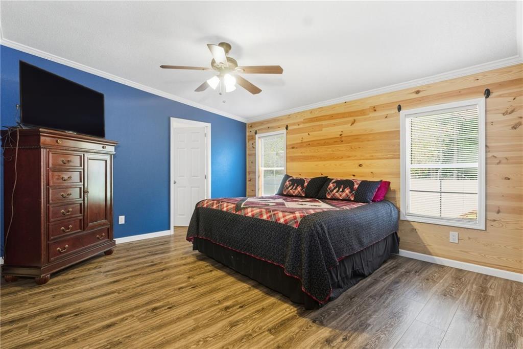 294 Old Ball Ground Road Canton, GA 30115 - Photo 28 of 40 a bedroom with a bed and a flat tv screen on dresser