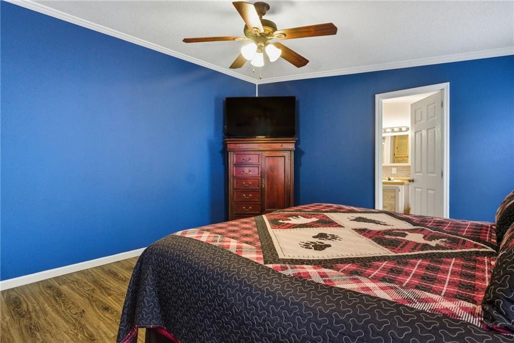 294 Old Ball Ground Road Canton, GA 30115 - Photo 29 of 40 a bedroom with a bed and a flat screen tv