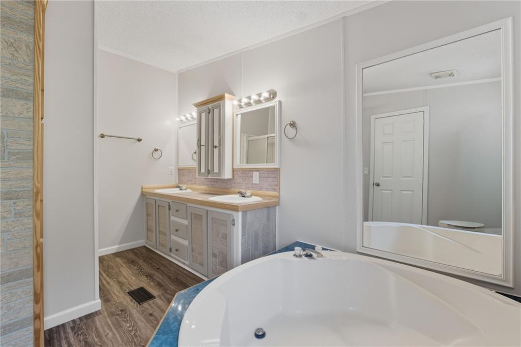 294 Old Ball Ground Road Canton, GA 30115 - Photo 33 of 40 a bathroom with a tub sink mirror and shower