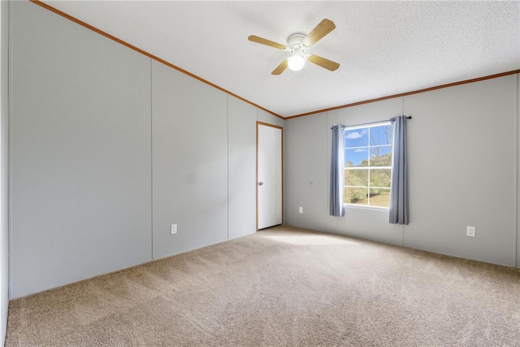 294 Old Ball Ground Road Canton, GA 30115 - Photo 34 of 40 an empty room with windows and painted walls