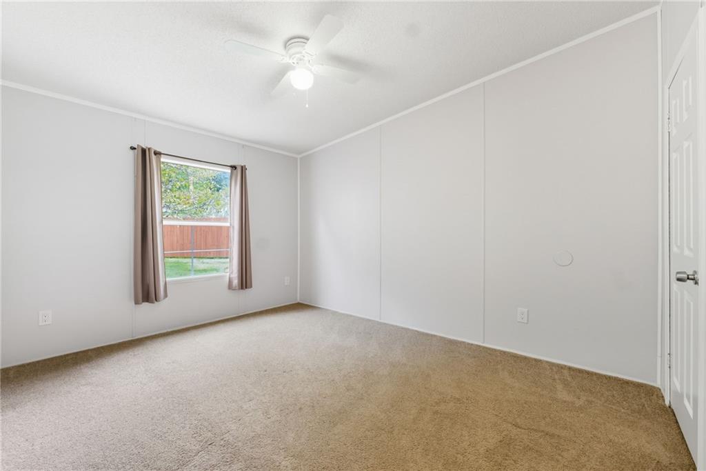 294 Old Ball Ground Road Canton, GA 30115 - Photo 35 of 40 an empty room with a window and a ceiling fan