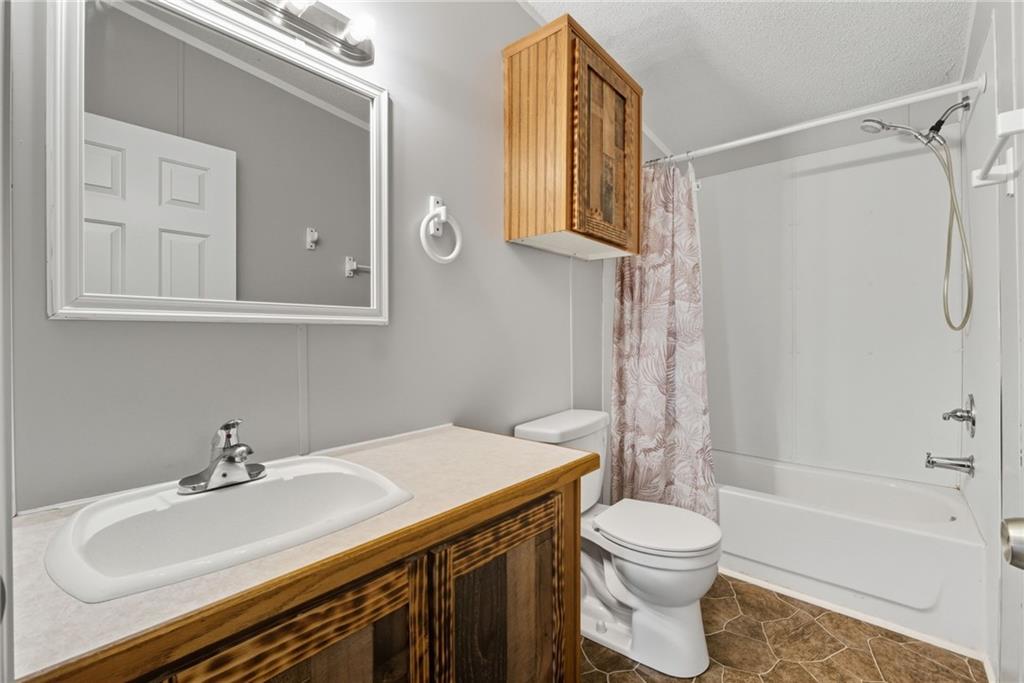 294 Old Ball Ground Road Canton, GA 30115 - Photo 36 of 40 a bathroom with a sink toilet and shower