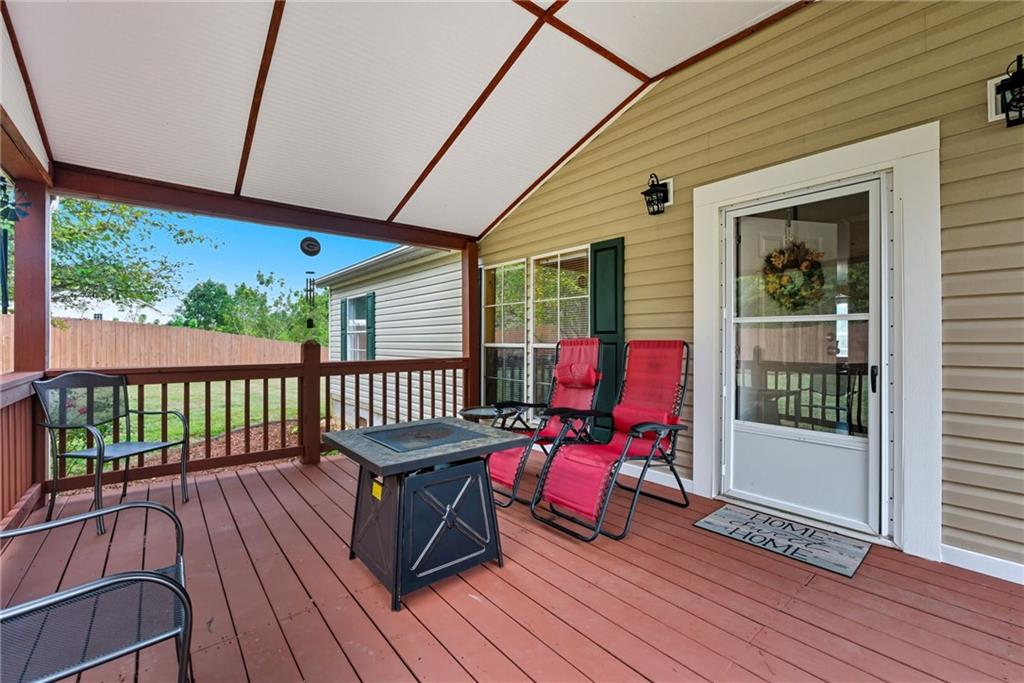 294 Old Ball Ground Road Canton, GA 30115 - Photo 40 of 40 a view of a deck with wooden floor and outdoor seating