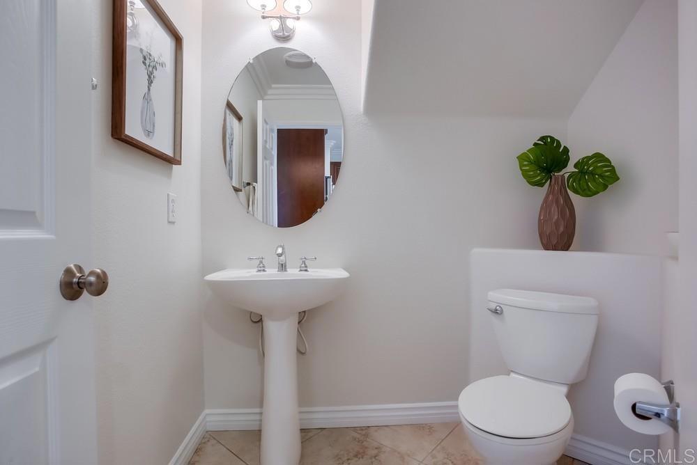 4142 Karst Road Carlsbad, CA 92010 - Photo 11 of 31 a bathroom with a toilet sink and mirror