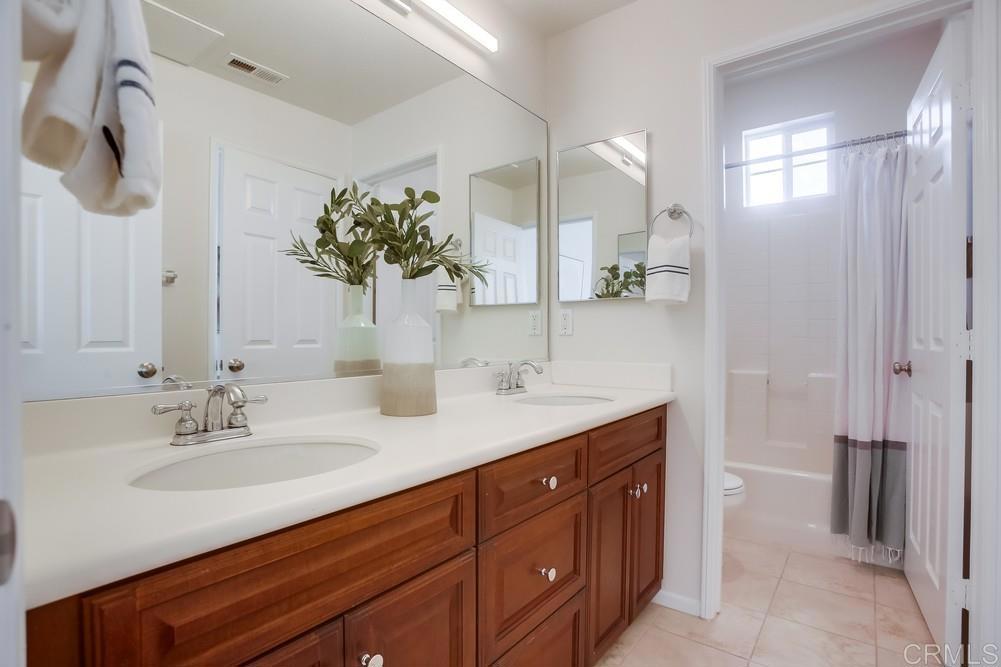 4142 Karst Road Carlsbad, CA 92010 - Photo 26 of 31 a bathroom with a sink double vanity and a mirror