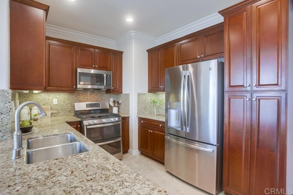 4142 Karst Road Carlsbad, CA 92010 - Photo 8 of 31 a kitchen with stainless steel appliances granite countertop a refrigerator stove and microwave