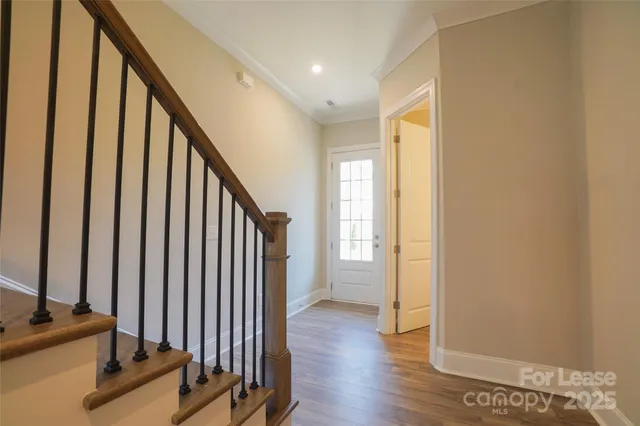 a view of a room with wooden floor and staircase