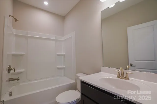 a bathroom with a granite countertop sink toilet and bathtub