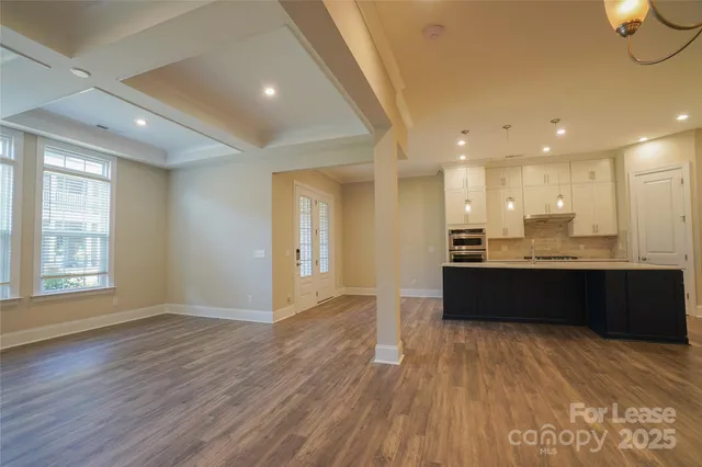 a view of kitchen with wooden floor and window