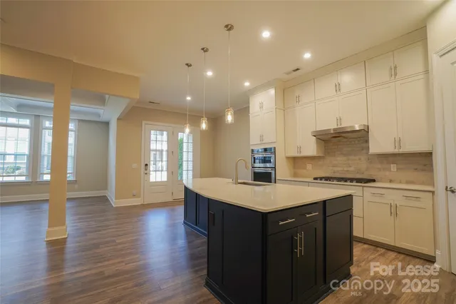 a kitchen with a sink stove and cabinets