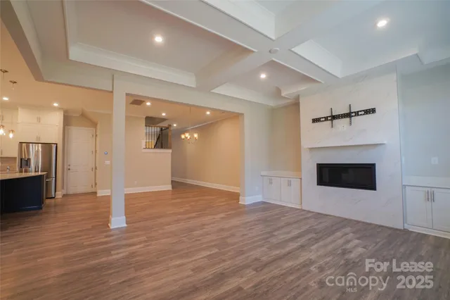 a view of a livingroom with a fireplace and a ceiling fan
