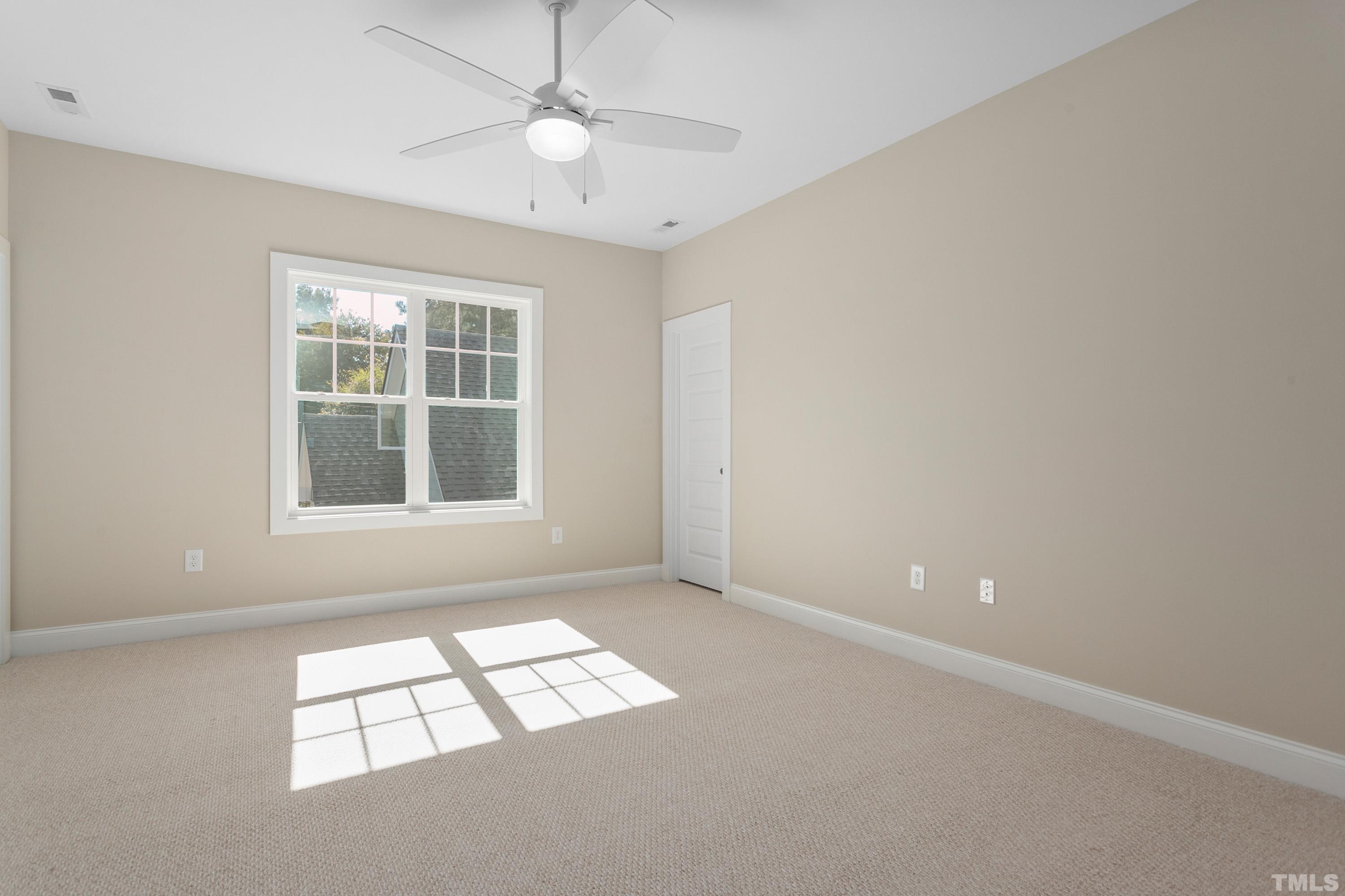 202 Myers Avenue Raleigh, NC 27604 - Photo 20 of 26 an empty room with windows and chandelier fan