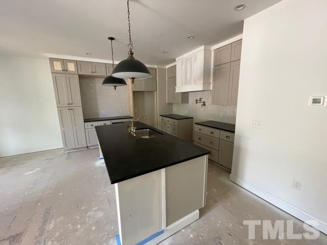 202 Myers Avenue Raleigh, NC 27604 - Photo 3 of 26 a kitchen with granite countertop a sink and a stove
