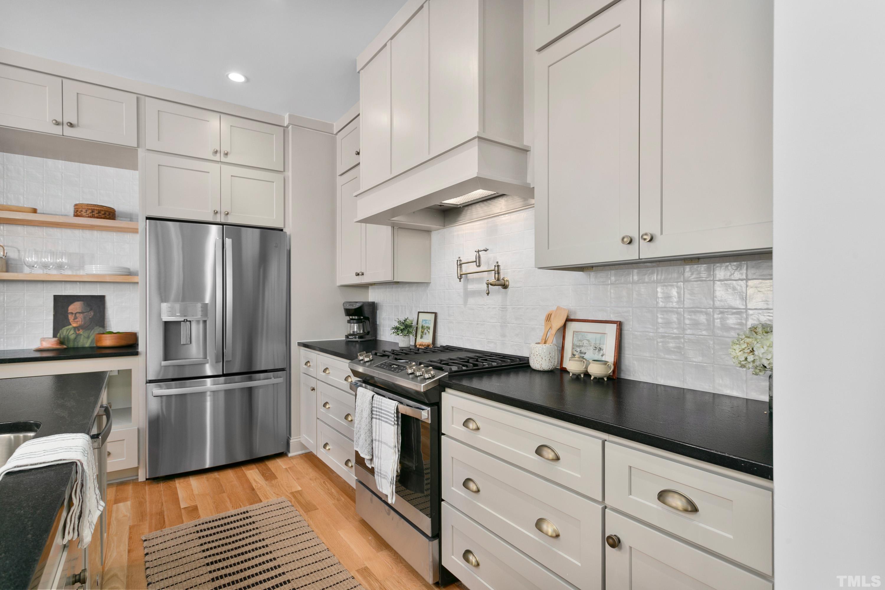 202 Myers Avenue Raleigh, NC 27604 - Photo 6 of 26 a kitchen with granite countertop a sink stainless steel appliances and cabinets