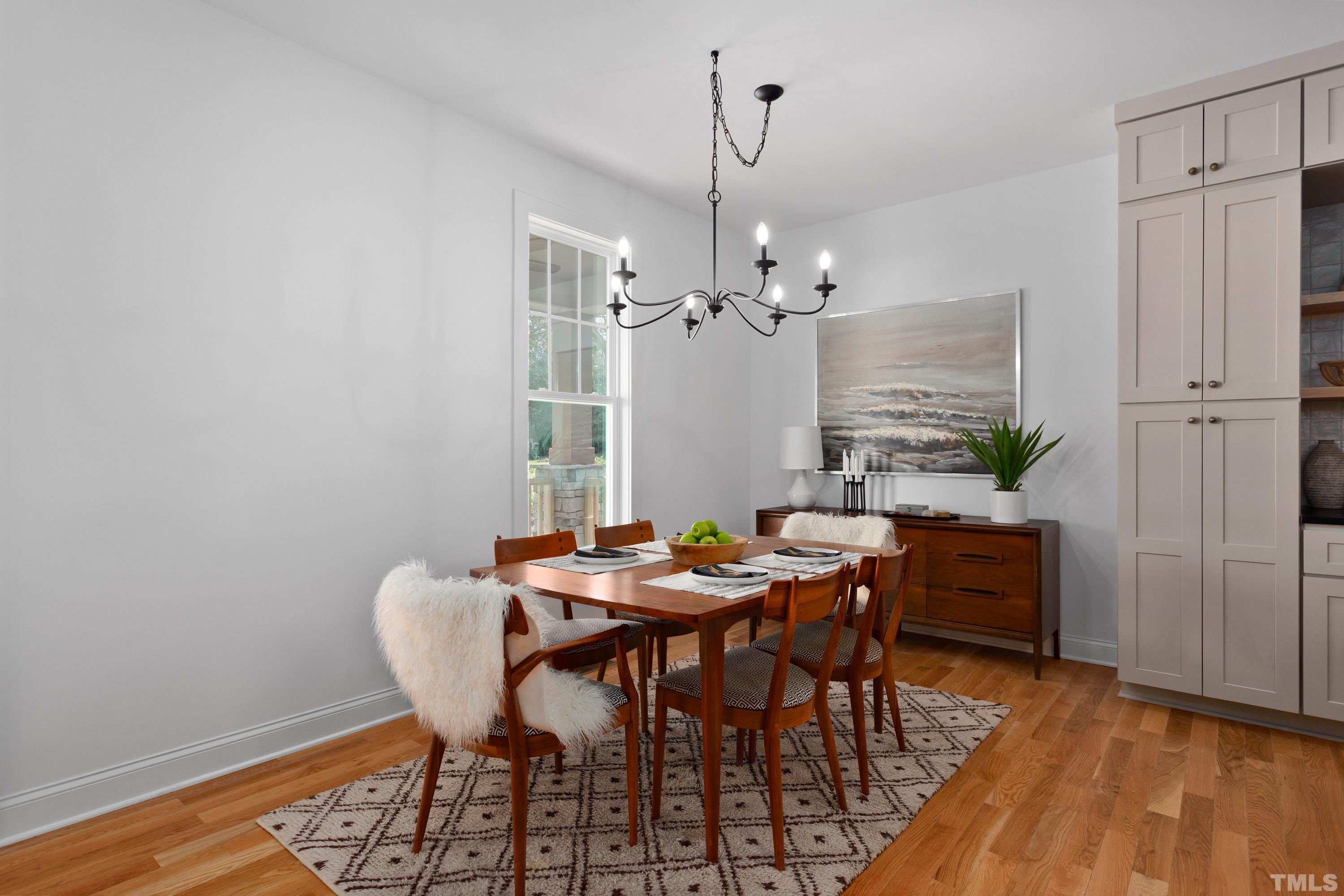 202 Myers Avenue Raleigh, NC 27604 - Photo 9 of 26 a view of a dining room with furniture and wooden floor