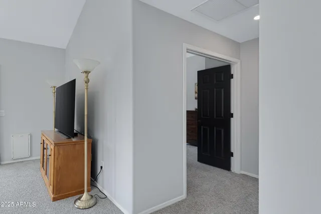 a view of a workspace with furniture and a flat screen tv