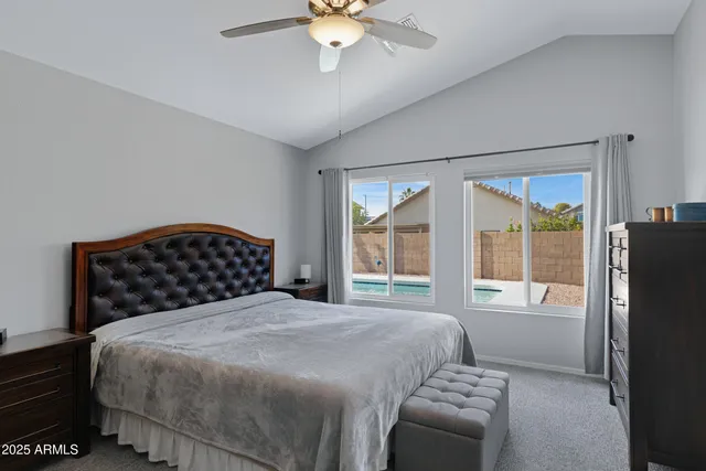 a bedroom with a large bed and a large window