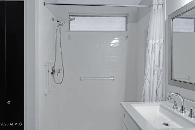 a bathroom with a sink and mirror