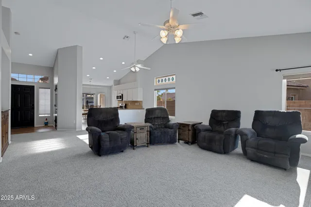 a living room with furniture and a chandelier