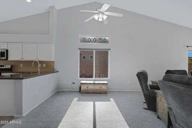 a living room with furniture and a piano