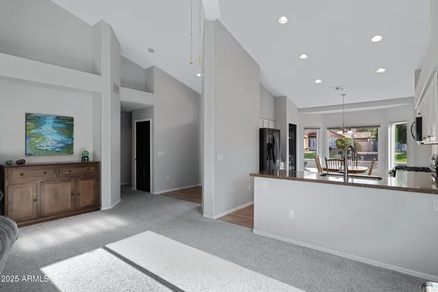 a view of a kitchen with refrigerator and window