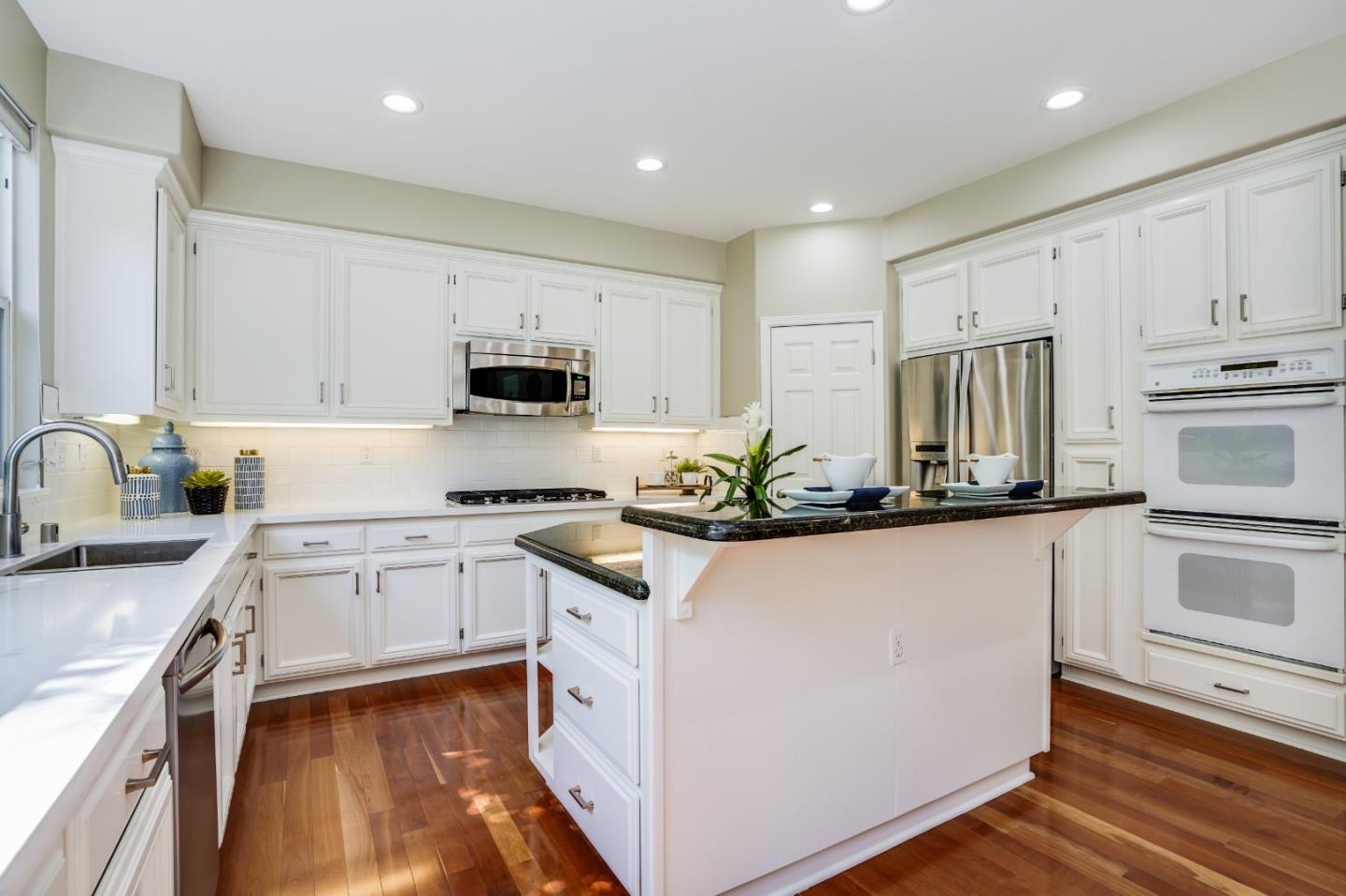 5929 Lantana Way San Ramon, CA 94582 - Photo 14 of 61 a kitchen with granite countertop white cabinets and white appliances