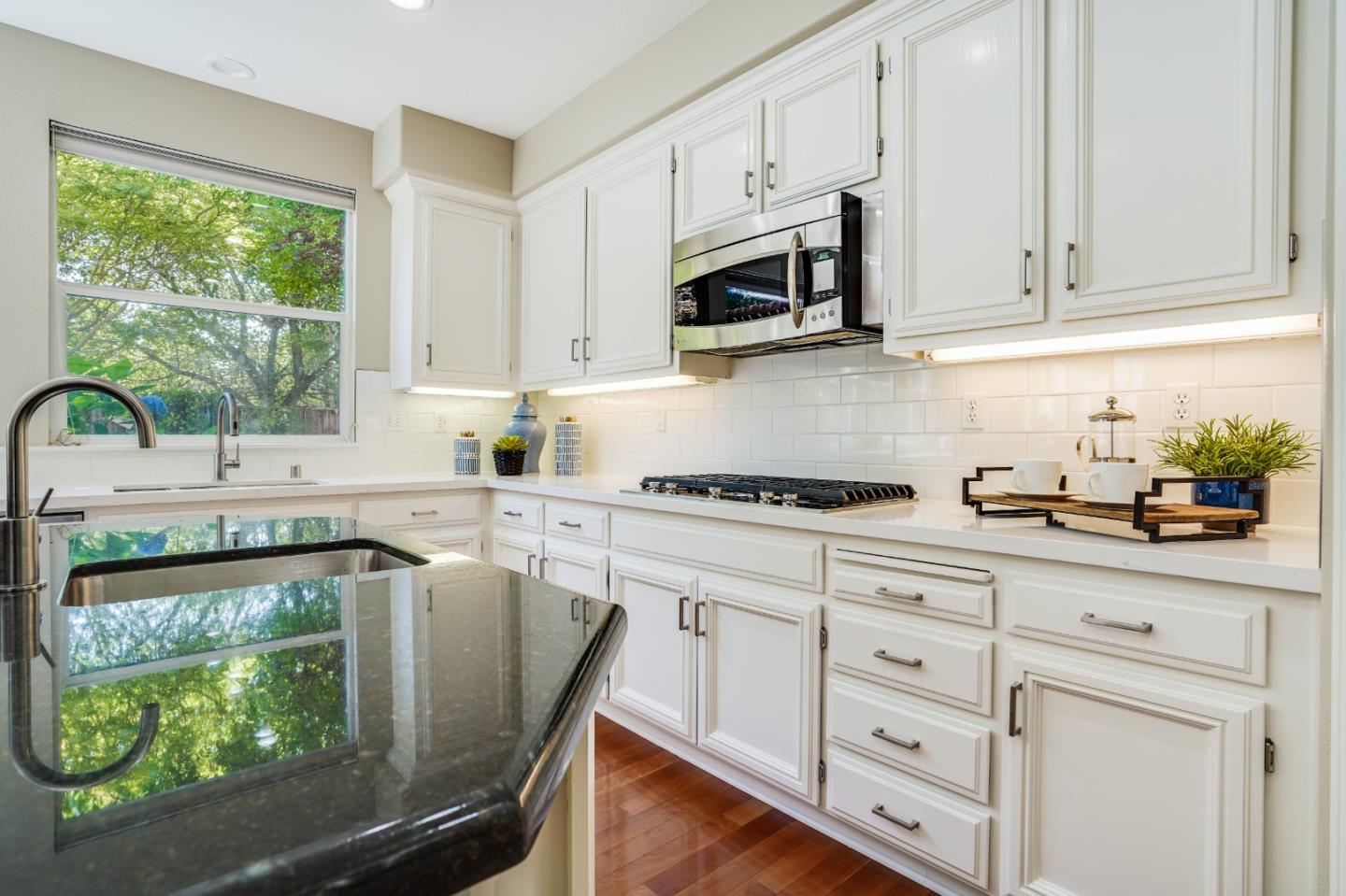 5929 Lantana Way San Ramon, CA 94582 - Photo 15 of 61 a kitchen with stainless steel appliances granite countertop a sink a stove and white cabinets with wooden floor
