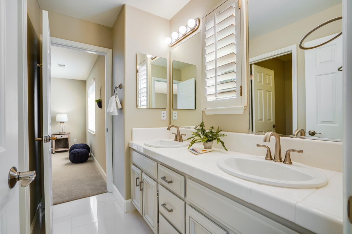 5929 Lantana Way San Ramon, CA 94582 - Photo 41 of 61 a en suite bathroom with a double vanity sink and a mirror