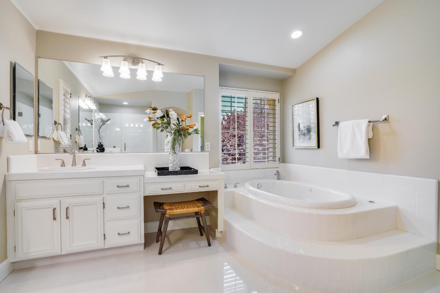 5929 Lantana Way San Ramon, CA 94582 - Photo 50 of 61 a spacious bathroom with a sink a large mirror and a bathtub