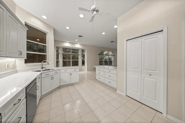 a kitchen with granite countertop a stove sink and cabinets