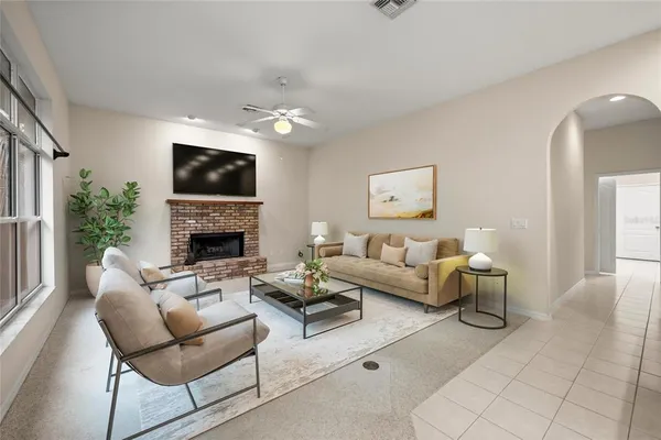 an empty room with windows and fireplace
