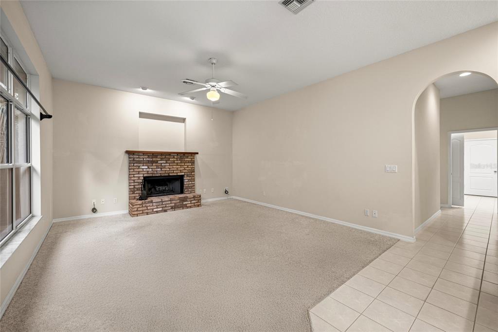 20698 Southwest 93rd Lane Road Dunnellon, FL 34431 - Photo 16 of 34 an empty room with windows and fireplace
