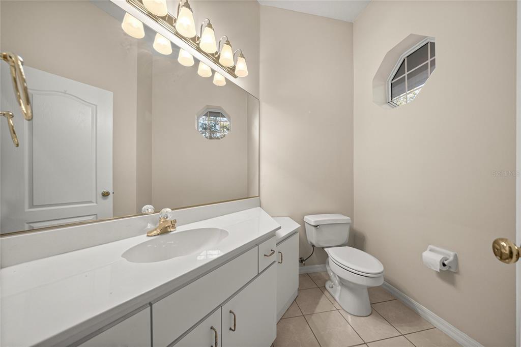 20698 Southwest 93rd Lane Road Dunnellon, FL 34431 - Photo 24 of 34 a bathroom with a sink a toilet and a mirror