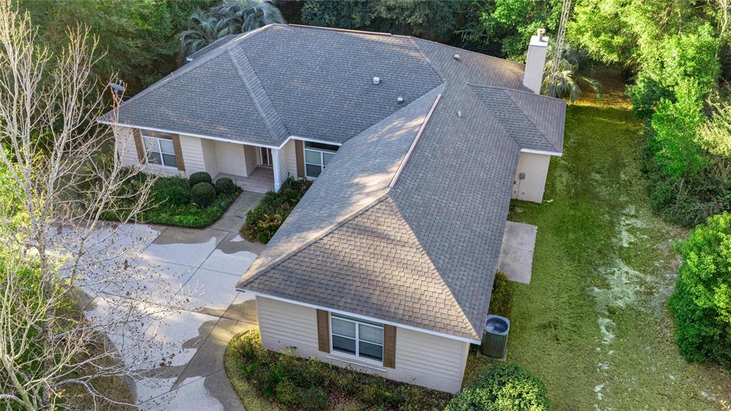 20698 Southwest 93rd Lane Road Dunnellon, FL 34431 - Photo 33 of 34 an aerial view of a house with a yard and large trees