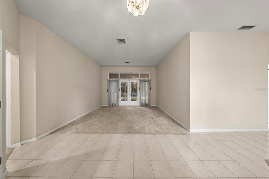 20698 Southwest 93rd Lane Road Dunnellon, FL 34431 - Photo 9 of 34 a view of an empty room with wooden floor and a window