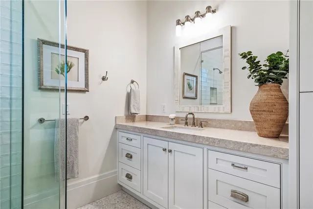 a bathroom with a granite countertop sink vanity granite and a mirror