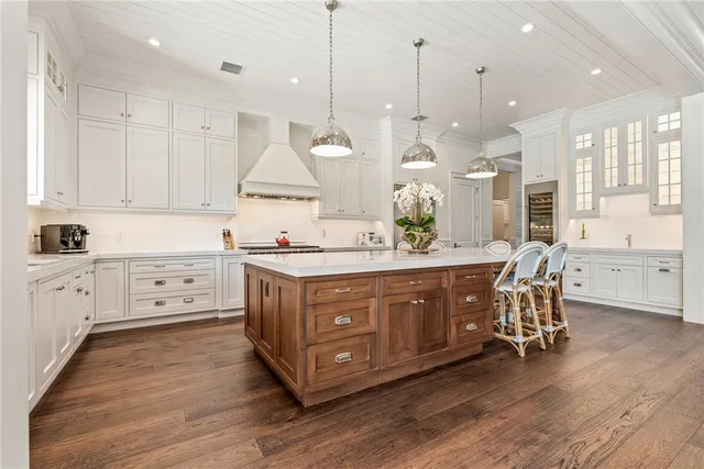 a large kitchen with stainless steel appliances a large counter space a sink and cabinets