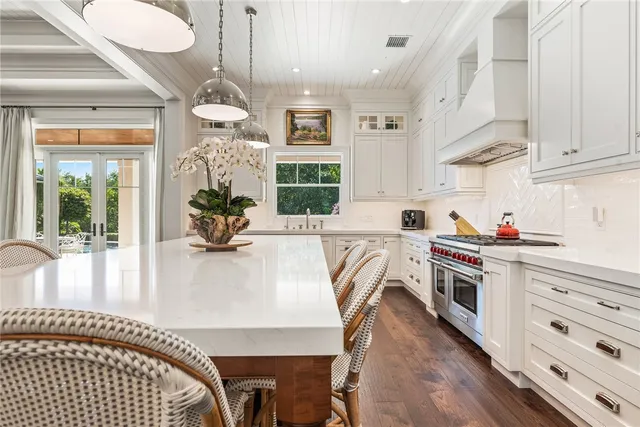 a kitchen with stainless steel appliances granite countertop a stove refrigerator and cabinets