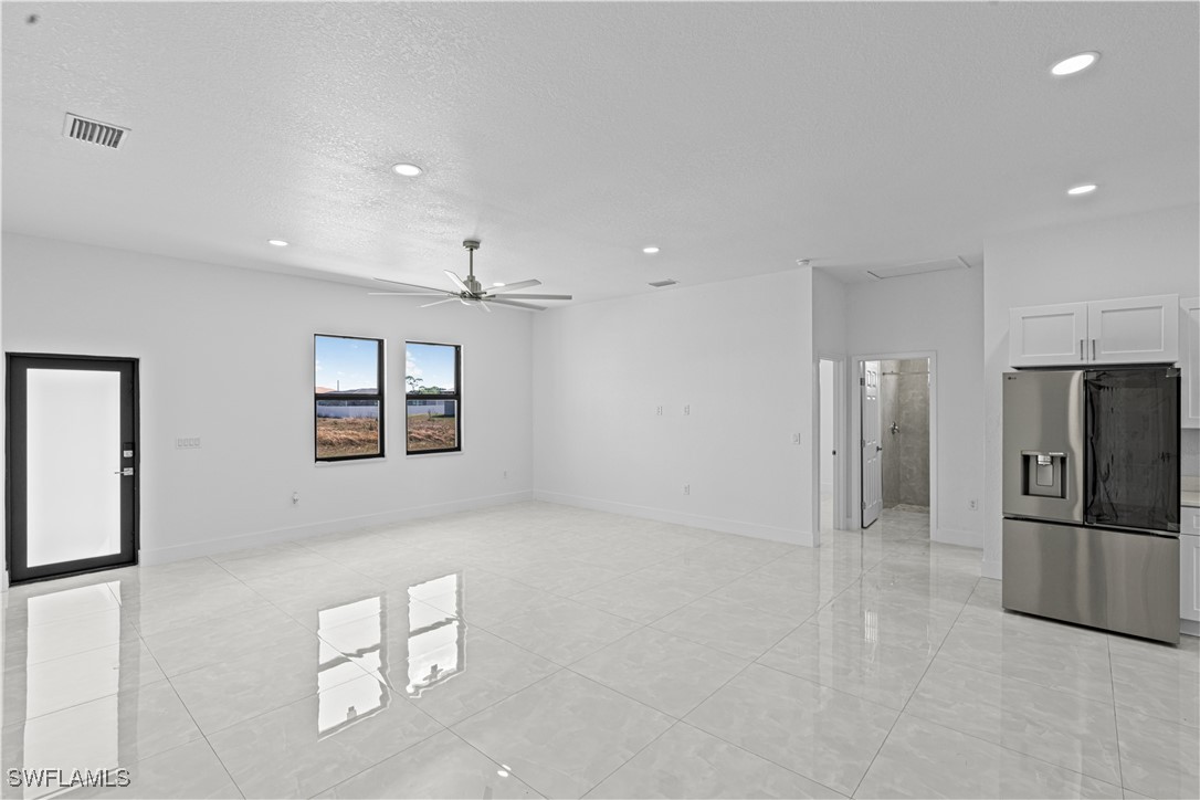 7029 Hero Court LaBelle, FL 33935 - Photo 11 of 36 a view of a kitchen with a refrigerator a kitchen counter top space and stainless steel appliances