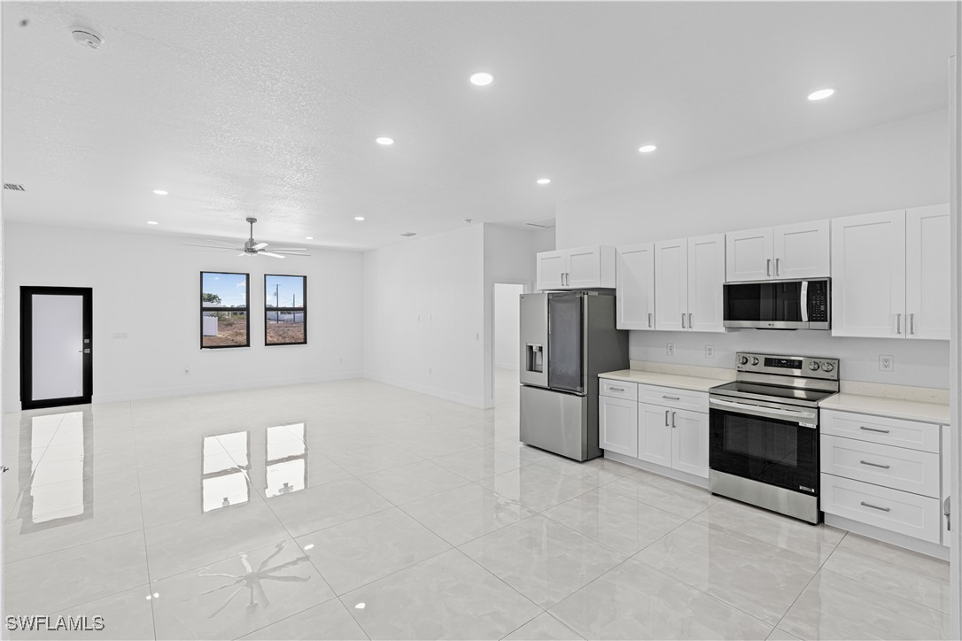 7029 Hero Court LaBelle, FL 33935 - Photo 16 of 36 a kitchen with stainless steel appliances a refrigerator sink and stove