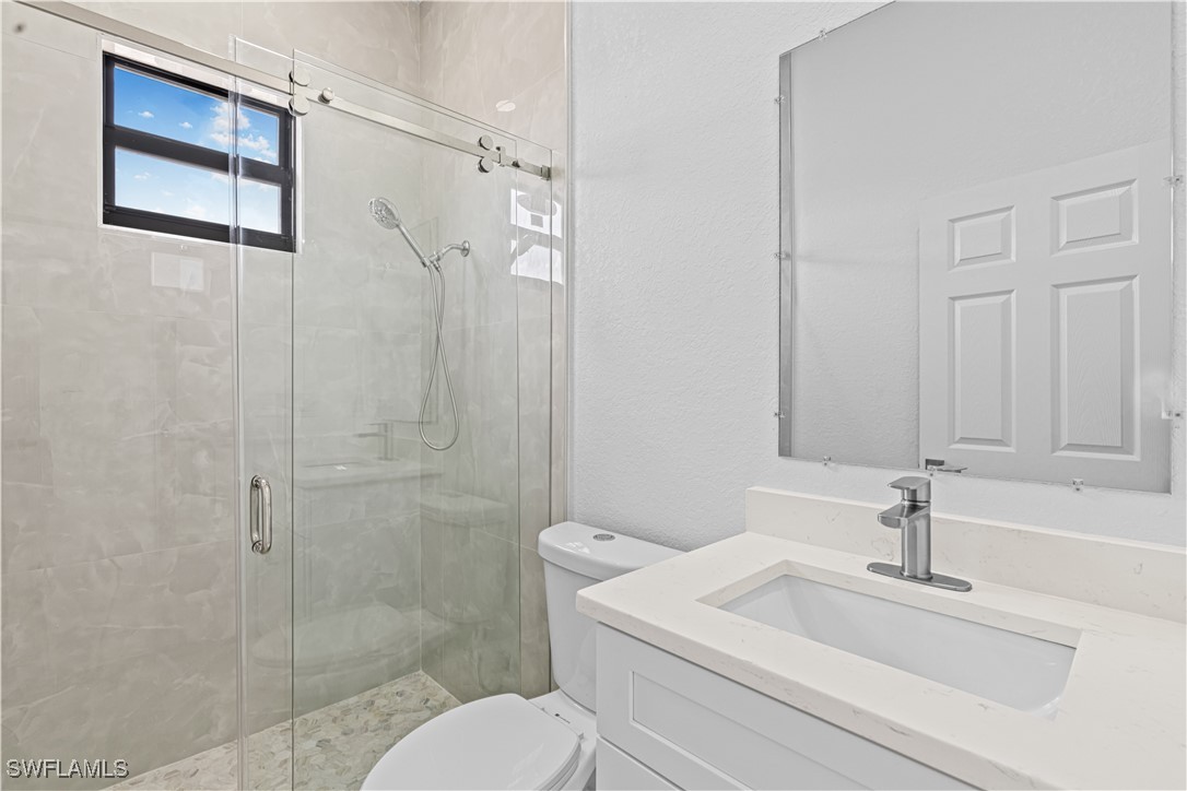 7029 Hero Court LaBelle, FL 33935 - Photo 24 of 36 a bathroom with a sink a toilet and shower