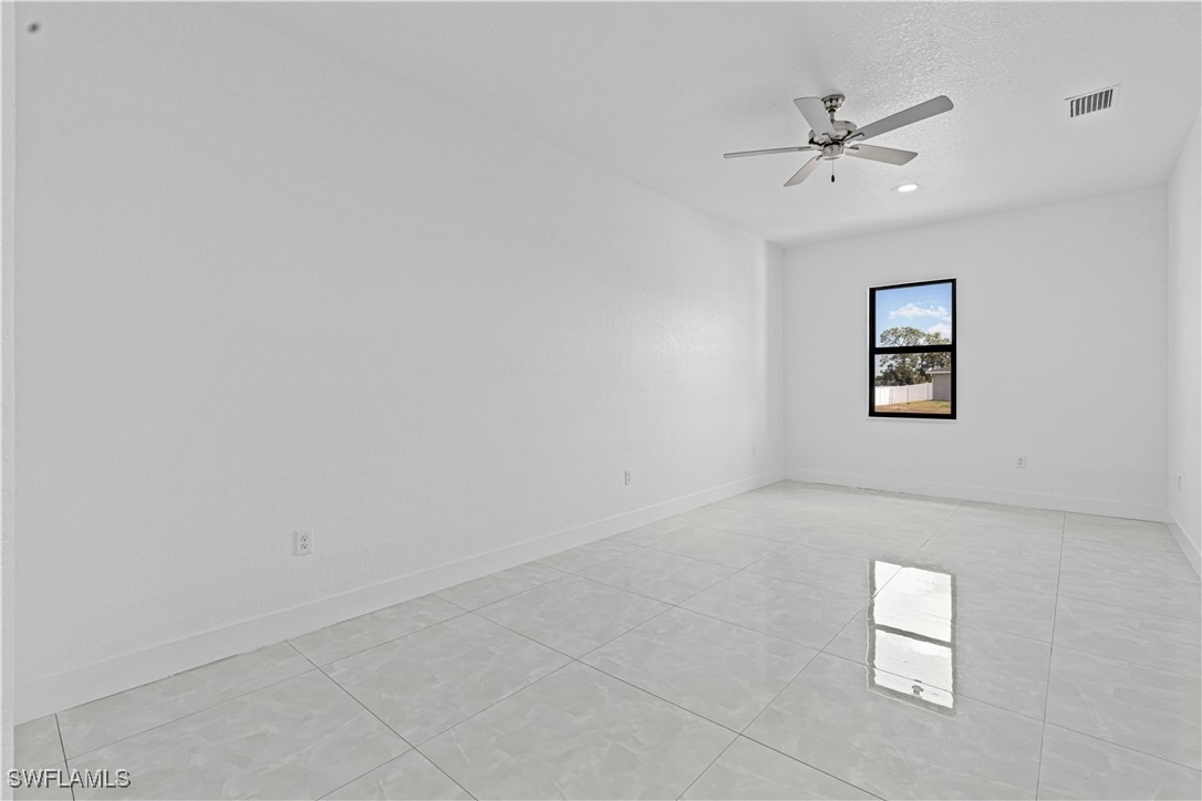 7029 Hero Court LaBelle, FL 33935 - Photo 25 of 36 an empty room with windows and fan