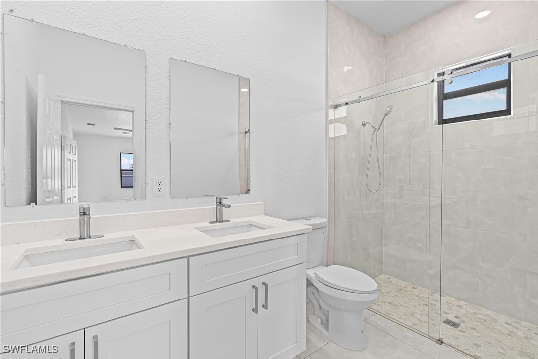 7029 Hero Court LaBelle, FL 33935 - Photo 28 of 36 a bathroom with a sink a toilet and shower