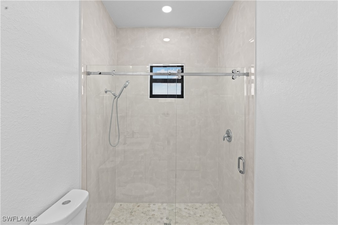 7029 Hero Court LaBelle, FL 33935 - Photo 29 of 36 a bathroom with a shower a toilet and sink