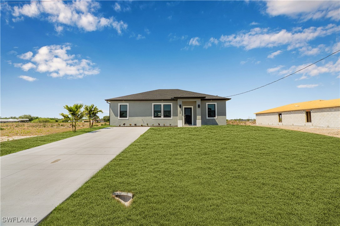 7029 Hero Court LaBelle, FL 33935 - Photo 6 of 36 a front view of a house with a yard