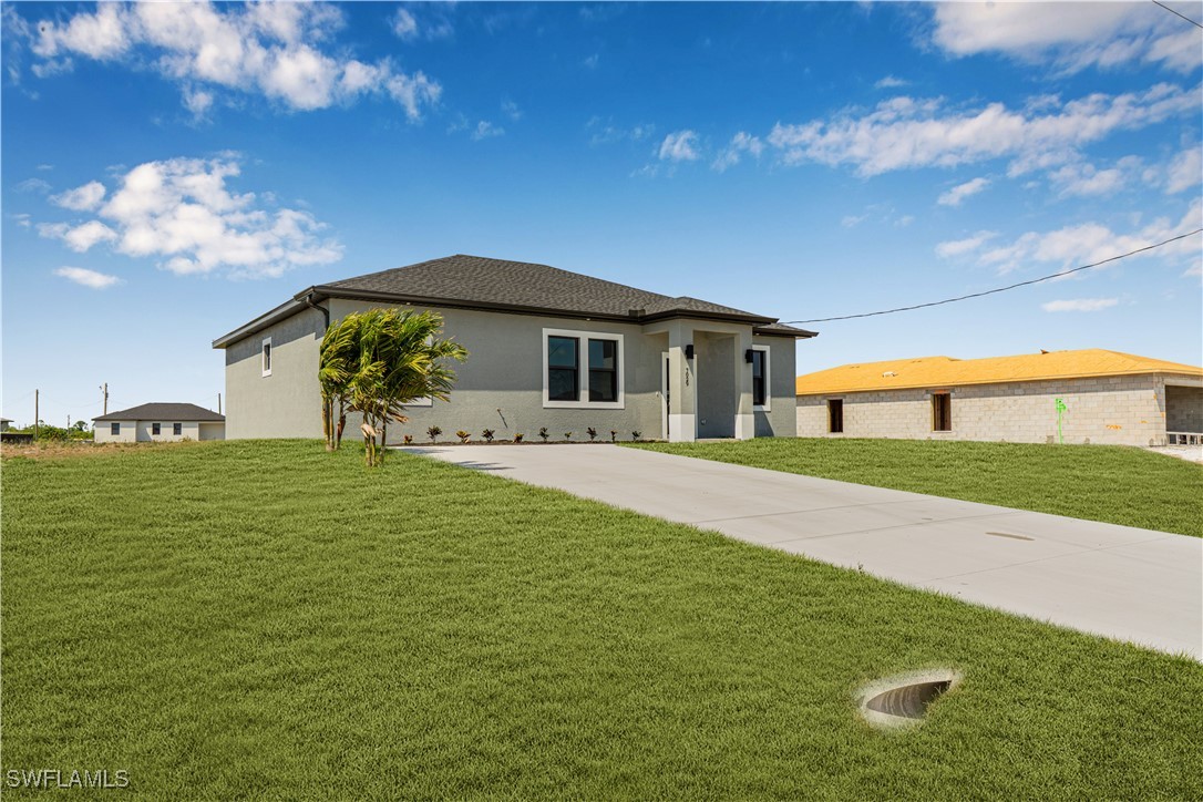 7029 Hero Court LaBelle, FL 33935 - Photo 9 of 36 a front view of a house with garden